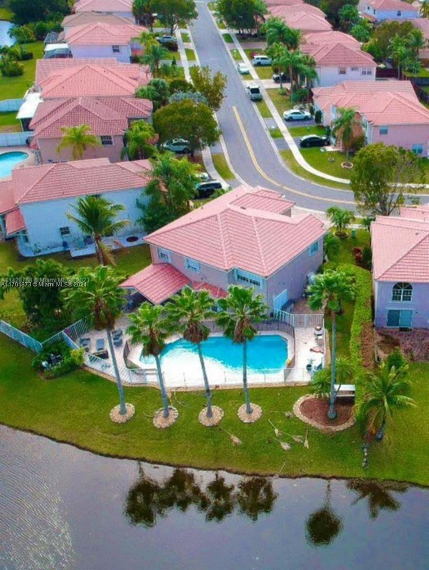 Beautiful single-family home with 2 stories, 4 beds & 3 full baths (2 upstairs & 1 downstairs) master bathroom has a jacuzzi, Living/din, Breakfast, sited on the second largest lot in the neighborhood, is a fenced lakefront lot with an amazing concrete roof over patio for BBQ & magnificenceSwimmingPool/Jacuzzi, accordion shutters. Great location and schools, low quarterly maintenance, wide Lakeview, master with 5 closets, dual sinks, and separate Roman tub and shower. Almost all areas overlook the lake. Great home. The A/C and water heater were renovated 3 years ago, garage floor has a special coating to prevent stains and bumps.3D TOUR IS AVAILABLE IN VIRTUAL TOUR, 24 hours in advance is required for an appointment