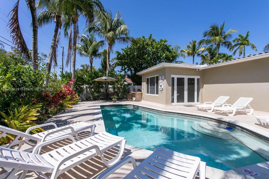 This beautifully upgraded 4-bedroom, 2-bath home is just minutes from Hollywood Beach yet tucked away in a quiet neighborhood. The open-concept living and dining area features ceramic tile floors, a spacious kitchen with ample cabinetry, pull-out drawers, and butcher block countertops. Recessed lighting, ceiling fans, and impact windows enhance the bright, airy feel. Enjoy a heated pool with LED lights, an outdoor kitchen with a mini fridge and gas BBQ—perfect for entertaining. Fully equipped with short-term rental licenses which is ideal for a lucrative investment or part-time residence. The seller is offering another property down the road (MLS# A11757557) and is willing to sell both homes together at a combined bulk price of $1,799,000. Don’t miss this incredible investment opportunity!