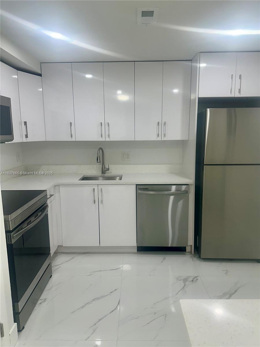 Completely updated 2 bed, 2 bath condo in Inverrary with tile floors throughout, modern kitchen with quartz counters and stainless steel appliances, and two fully renovated bathrooms. Enjoy the convenience of in-unit washer/dryer, a spacious walk-in closet, and a screened-in balcony with peaceful views. Quiet, secure building close to shopping, dining, parks, and major highways. Move-in ready!