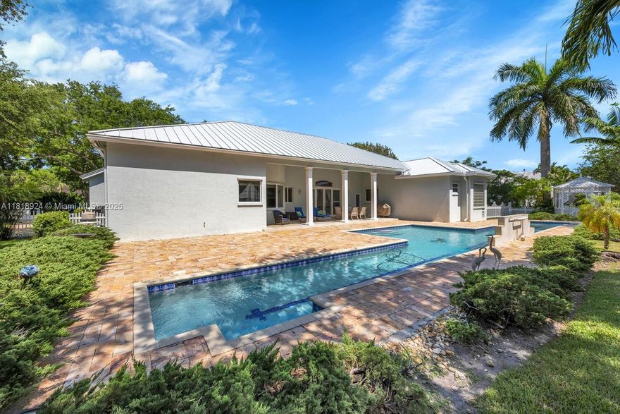 Enjoy the tranquil serenity of this custom built home located on a private cul-de-sac. The home sits on 19,000 sqft with 5 beds & 3 baths including a lavish master suite with custom cedar double closets & a spa inspired bathroom boasting dual vanities & a jacuzzi tub. At the heart of the home is a meticulously updated kitchen with quartz countertops & new high-end appliances highlighted by recessed lighting. The cabana bathroom leads directly to the patio of your backyard oasis, where a 25-yard lap pool with tiled lane line, a leisure swimming area and waterfall await. The home features a new metal roof, impact windows, & hurricane-rated garage doors, ensuring year-round comfort & safety. The home also boasts 2 new ACs, a new salt water system / pool pump & pool heating / cooling system.