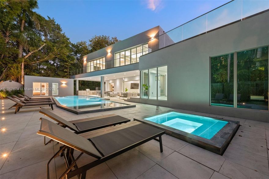 Stunning & contemporary style 5/6 estate pool home located in the highly sought after South Coconut Grove! Nestled on 11,000 SqFt this property combines the qualities of luxury + functionality throughout. This fully automated home is complemented by state of the art technology, prime quality materials, panoramic sliding pocket doors & gourmet italian kitchen amongst other prime features. Gorgeous private outdoor area w/ lush landscaping, outdoor kitchen, pool area + separate in law suite! Outside you are welcomed by a rich blue pool + oversized Jacuzzi w/ a cabana. The summer kitchen features all the appliances you could ask for. Perfect for entertaining! In home gym! Excellent location near restaurants, shoppings, transportation & more!