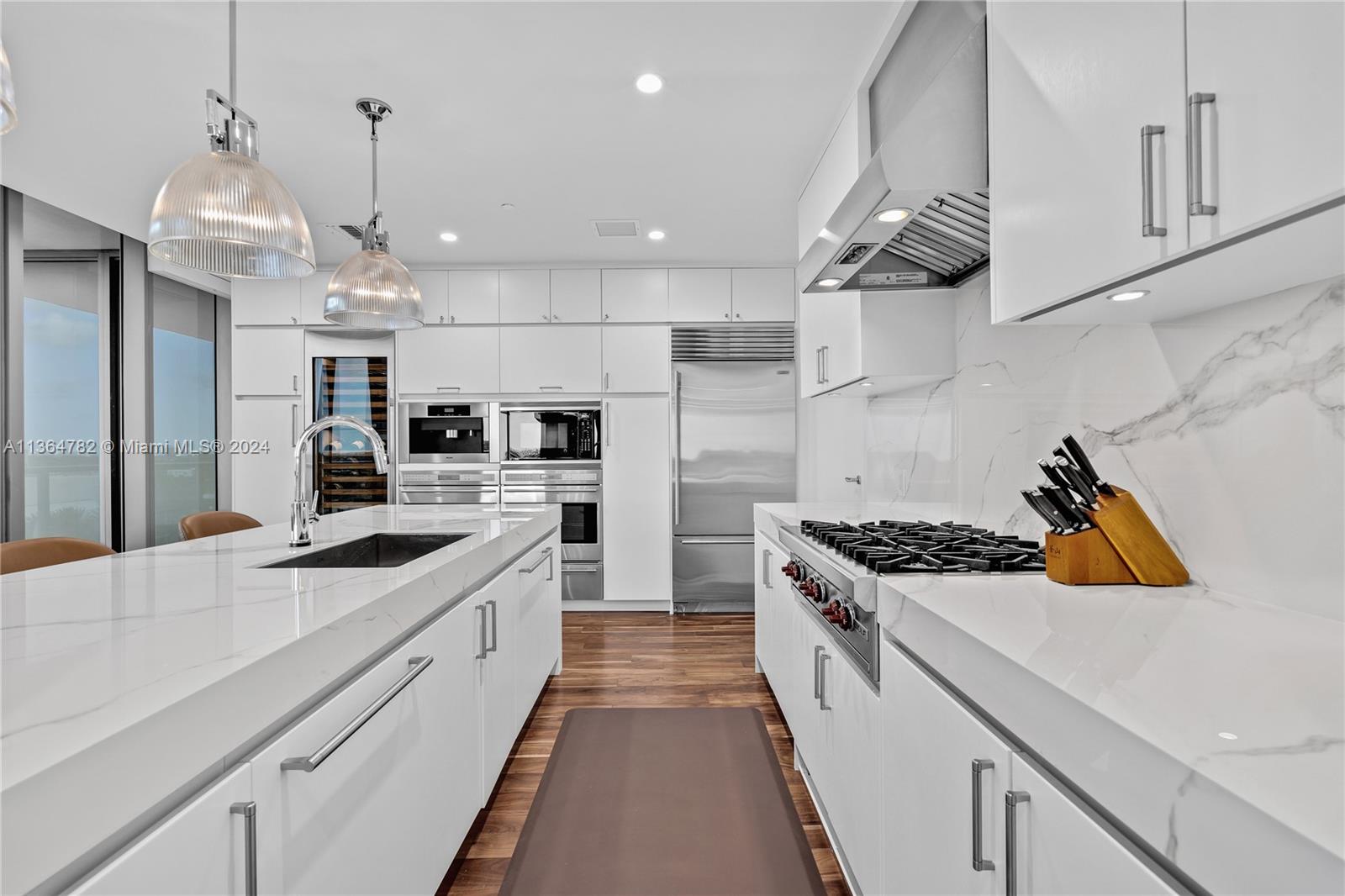 Newly updated direct ocean view flowthrough home at the St. Regis Residences in Bal Harbour. This 2,840 SF residence features versatile living, adaptable as either a 3 or 4-bedroom home. Recently renovated with neutral luxurious finishes. Spacious layout features a chef’s kitchen with Miele, Subzero, & Wolf appliances, a full-height wine fridge, and a large living area that flows seamlessly into a dining room & family room. The master suite is a private retreat, while the expansive bay side terrace boasts views over the Atlantic Ocean, Biscayne Bay, and the Miami skyline. Enjoy the St. Regis amenities, including full hotel services, exclusive resident facilities, and direct beach access. Perfect for creating lasting family memories, whether as a primary or a second home.