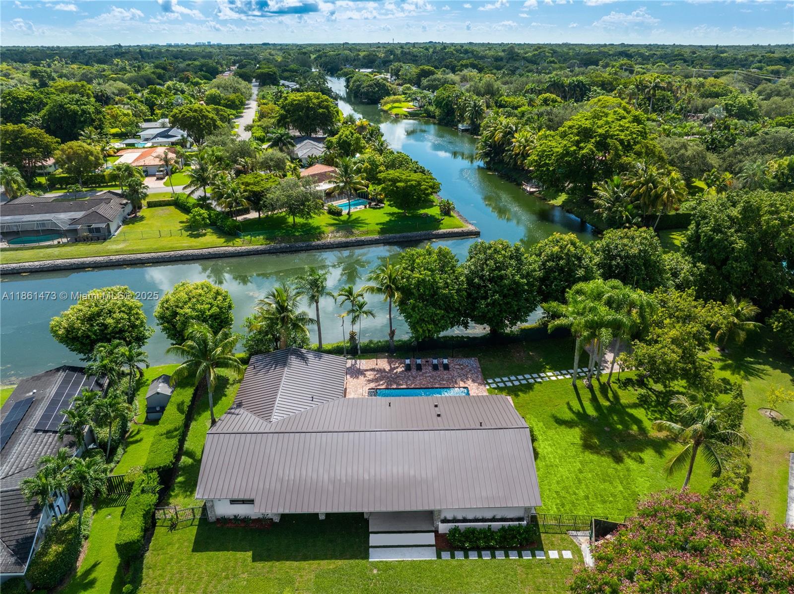 Set on an oversized 21,000 sq.ft. lot, this property offers a spectacular and rare view of the junction of two canals, making it truly one of a kind in Pinecrest. A unique opportunity to purchase a fully remodeled, like-new home, featuring all-new plumbing, electrical, A/C, floors, and impact windows. A grand reception area opens to stunning canal views, while the spacious kitchen includes abundant storage, a large island bar, and seamless flow to living areas. Additional features include a generous playroom, laundry with sink, and versatile layout: two bedrooms with Jack & Jill bath, an additional suite with shower and separate toilette, two bedrooms sharing a bath, and a master suite with walk-in closet and large bath. 245sq ft lineal over canal.