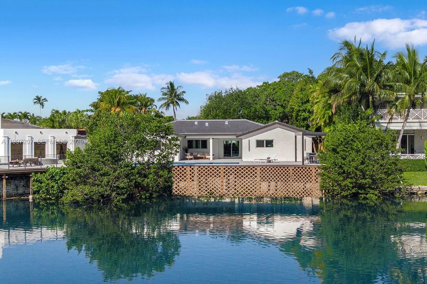 Nestled within the prestigious guard-gated community of Enchanted Lakes, this impeccably renovated waterfront residence embodies refined South Florida living. Thoughtfully updated throughout, the home features a new 2025 roof, upgraded electrical and plumbing systems, new insulation, drywall, ductwork, and two high-efficiency air conditioning systems. The interiors are defined by a seamless open-concept layout with great ceilings and elegant floor-to-ceiling Italian doors that flood the home with natural light. A MiaCucina Italian kitchen is complemented by brand-new Dacor luxury appliances, while spa-inspired bathrooms, wide-plank flooring, and sophisticated LED lighting enhance the home’s modern aesthetic. Outdoors, a true waterfront lifestyle unfolds, where tranquil lake views set the backdrop for a newly designed pool, expansive deck, and newly constructed seawall with an expansive deck spanning the entire waterfront—creating an ideal setting for both relaxation and entertaining. The home reflects an actual area of 3,104 square feet per tax records; buyers are advised to verify all measurements. Perfectly positioned just minutes from Aventura, pristine beaches, major highways, and top-rated schools, this residence offers a rare blend of luxury, comfort, and convenience.