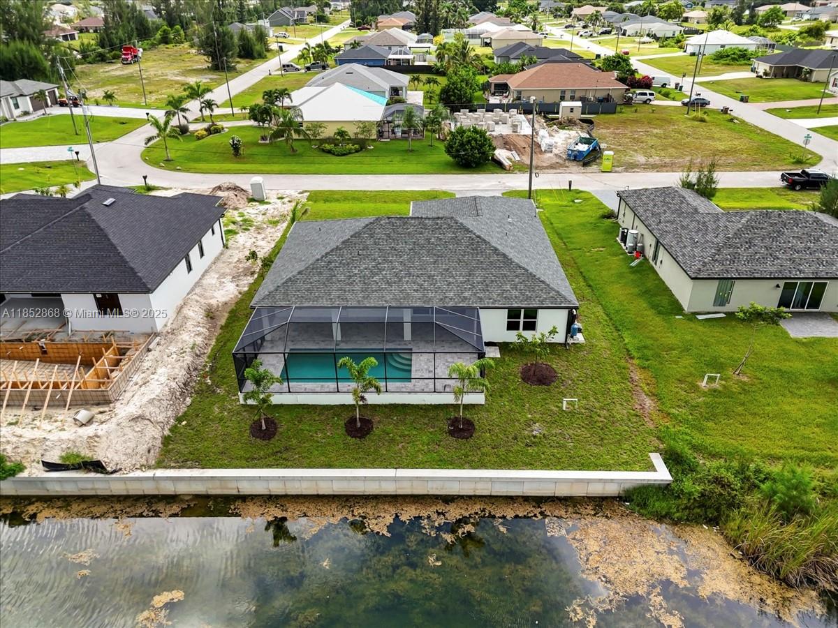 $15,000 BUILDER PAID CLOSING COSTS! WATERFRONT PARADISE WITH DUAL PRIMARY SUITES & HEATED POOL! Nestled on a scenic freshwater canal, this expansive 4-bedroom, 3-bath home offers serene water views and the perfect blend of comfort and elegance. The gourmet kitchen is a chef’s dream, featuring soft-close, all-wood cabinetry, quartz countertops, stainless steel appliances, and an oversized walk-in pantry—perfect for hosting and everyday convenience. Whether you love kayaking, fishing, or simply unwinding by the water, this home delivers the ultimate Florida lifestyle! Built by a trusted local builder, this home offers exceptional value with impact windows, no flood zone for peace of mind, and a 10-year structural warranty for lasting confidence. This is The Paradise Cove Plan