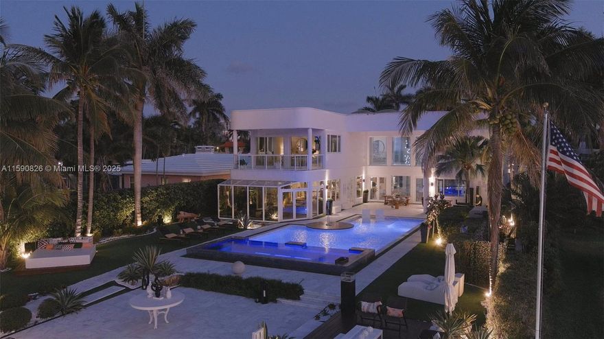HUGE PRICE CUT!!! PRICE TO SELL!!! ALL OFFERS WILL BE ENTERTAINED!!! WELCOME TO THIS MODERN MASTERPIECE AT 934 S SOUTHLAKE DRIVE LOCATED IN THE EXCLUSIVE ENCLAVE OF HOLLYWOOD, FLA, SITUATED ON A 17,000 SQ FT LOT, 6 BEDROOMS, 5.5 BATHROOMS, STATE-OF-THE-ART THEATRE ROOM, GYM, AND MAIDS QUARTERS. THIS HOME BOASTS ARCHITECTURAL DETAIL WITH LUXURIOUS FINISHES THROUGHOUT.
ENTERING THROUGH A 10-FOOT  EURO WALL PIVOT FRONT DOOR, THE LAMBORGHINI OF DOORS, YOU ARE IMMEDIATELY GREETED BY SOARING 26+FOOT CEILINGS FEATURING AN EXTRAORDINARY FLOOR-TO-CEILING FIREPLACE & CUSTOM GOURMET KITCHEN THAT OPENS INTO A VAST DINING ROOM THAT HOSTS A ONE-OF-A-KIND  CLIMATE CONTROL WINE CELLAR. COMPLEMENTED BY ELEGANT WHITE CALACATTA FLOORS. SEAMLESS INDOOR/OUTDOOR FLOW  WITH A MODERN POOL& ALL GLASS JACUZZI.