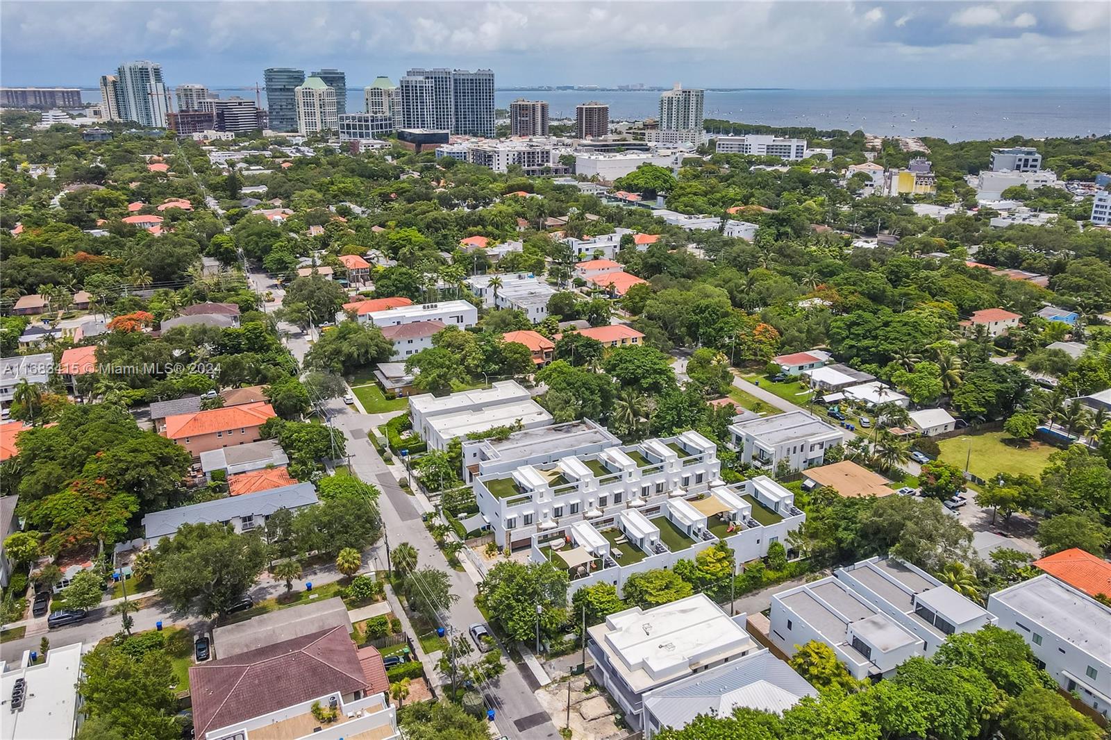 Exclusive Townhome centrally located in the heart of Coconut Grove in a gated community. Enjoy this 3 beds, 2.5 baths, plus an office space/den, and double car garage. Offers 2,577 sqft + 900 sqft of roof top with synthetic grass, 10.5' ceilings, fully equipped laundry room, walking closets in each room, gourmet contemporary island kitchen, Italian style cabinetry, stainless steel appliances, quartz counter tops. Quite & secured community with only 10 units. Nice neighbors & kids friendly. Amazing location, walking distance to all restaurants and assigned to Coconut Grove Elementary.
