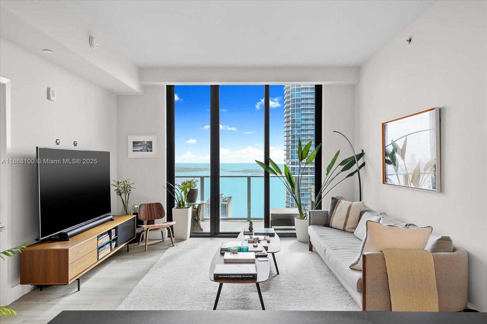 Experience elevated living in this stunning lower penthouse with a private elevator, high ceilings, and an open balcony offering breathtaking Biscayne Bay views. This 2-bedroom + den, 3-bath residence spans 1,283 SF of light-filled space, featuring tile floors, custom cabinetry, and floor-to-ceiling windows that capture panoramic water views. Resort-style amenities include a bar, basketball courts, billiard room, BBQ/picnic area, business center, clubhouse, fitness center, and hobby room. Enjoy the best of Brickell’s vibrant lifestyle with luxury, privacy, and world-class conveniences.
