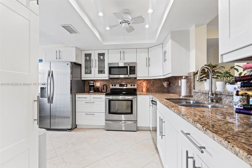 A warm welcome to this beautifully renovated & well maintained first-floor condo, offering 2 spacious en-suite bedrooms & 2 full bathrooms w/in a peaceful & friendly 55+ community that offers a comfortable, relaxing living lifestyle overlooking the peaceful, tranquil & professionally landscaped grounds. The home’s upgraded kitchen features granite countertops, sleek cabinetry, & newer appliances. Elegant porcelain floors flow throughout, new hurricane-impact PGT windows & sliders & in-unit full size washer/dryer, provide added peace of mind. An abundance of natural light entering all hours of the day. You’ll love the large walk-in closet, generous storage space throughout, an all season enclosed porch that can be used as additional living space or even for a home office!  With two assigned parking spaces right at your doorstep & easy access to the beautiful golf course, convenience is a given. Resort style amenities include two heated swimming pools, shuffleboard, a clubhouse inclusive of a gym, sauna, library, a function room, billiards & ping pong. An abundance of guest parking available. Cable & Internet are included at no additional cost. This turn-key home blends character with modern comforts in an UNBEATABLE LOCATION, just STEPS to local amenities, popular restaurants, businesses, golf courses, workout facilities, major retailers, shops, cafes, bakeries, recreational areas & highway access. DO NOT MISS THIS OPPORTUNITY TO MAKE THIS YOUR HOME! SCHEDULE YOUR TOUR TODAY!