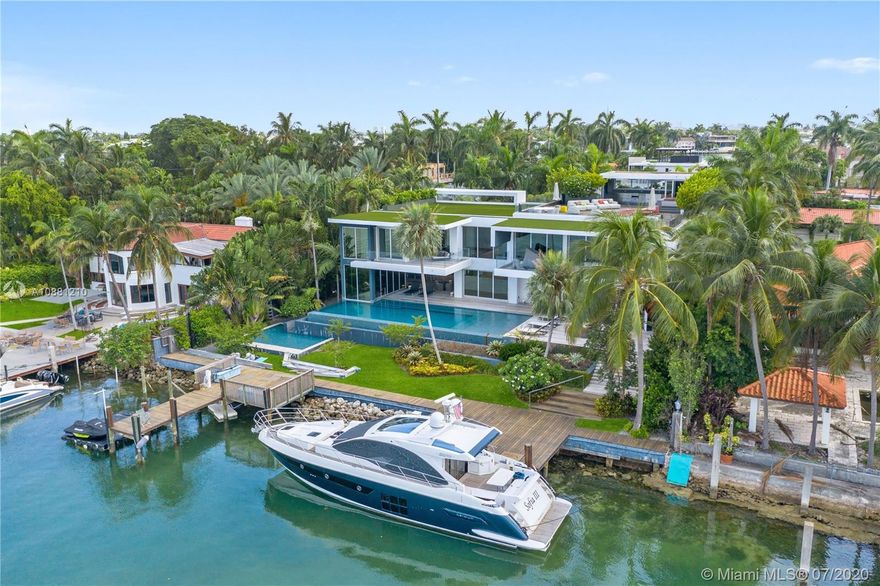 Exclusive Hibiscus Island Miami Beach modern architectural gem built 2016 on double lot w/122 ft of water frontage, South orientation. Designed by renowned architect Reinaldo Borges & landscape architect Raymond Jungles. 5B/5B + powder rm, white wood marble slab floors on 1st flr, wood plank floors on 2nd flr. State-of-the-art Crestron automation including all window shades, gourmet designer kitchen w/2 refrigerators Miele & SubZero, Wolf gas range, 2 wine coolers. Master bdrm w/ensuite office, 2 walk-in closets/dressing areas. Bowers & Wilkins home theatre, children’s playrm, 2nd flr living area, elevator, dbl laundry rm + dry storage. 2 heated pools + sauna, cabana bthrms, outdoor living area w/complete kitchen & bar. Rooftop w/360 skyline views, jacuzzi & kitchen. 4 car garage, 2 docks.