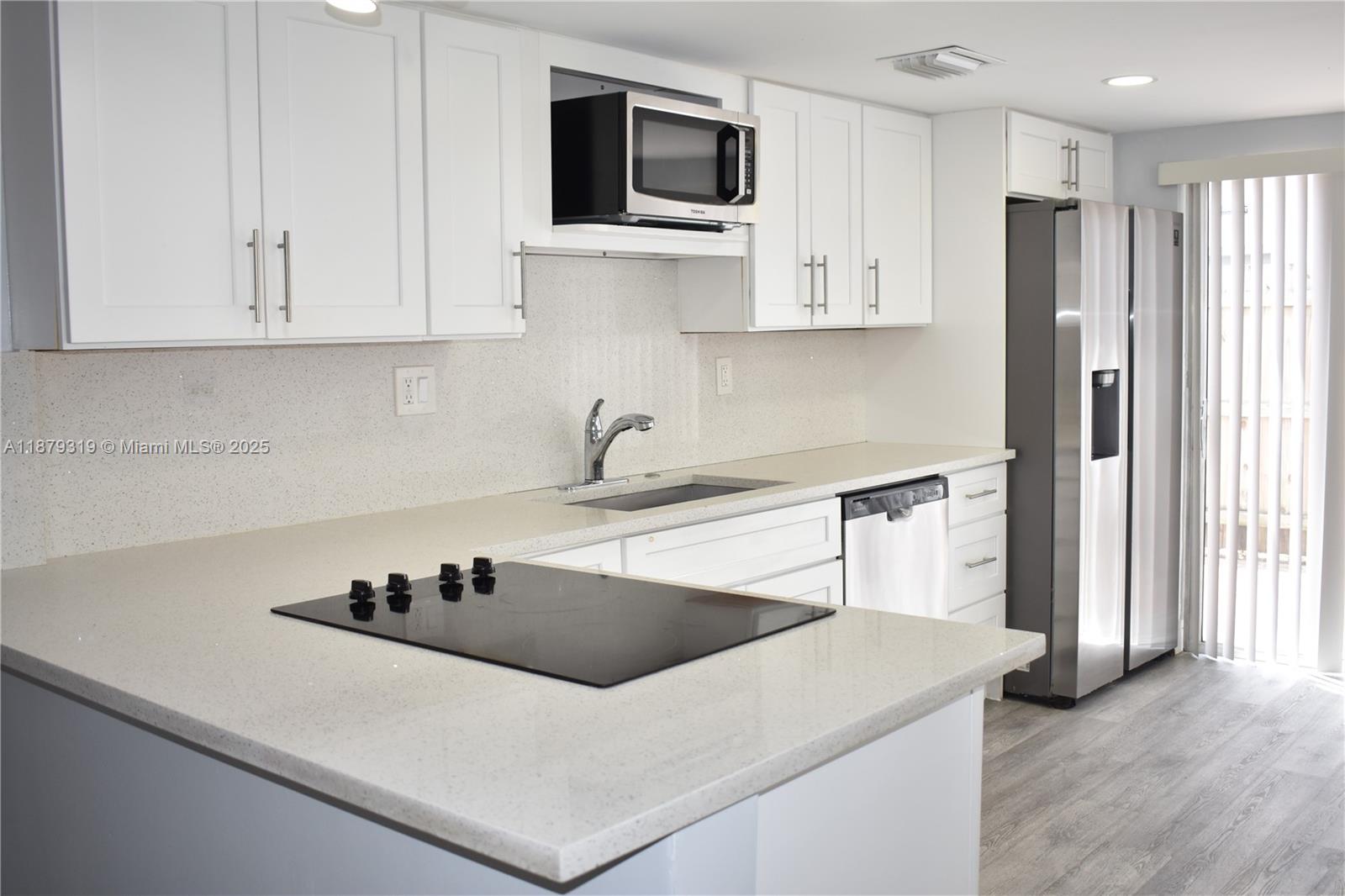 This charming modernized unit offers a spacious layout and an unbeatable location just minutes from the highway. Enjoy a fully renovated kitchen featuring granite countertops, a sleek electric cooktop seamlessly embedded into the counter, stylish backsplash, and stainless steel appliances. Both bathrooms have been tastefully updated for a fresh, contemporary feel. The master bedroom includes an en-suite bath for added privacy. Outside, relax or entertain in your private, fenced-in patio area. Only a short drive to the beach, this home is truly a must-see!