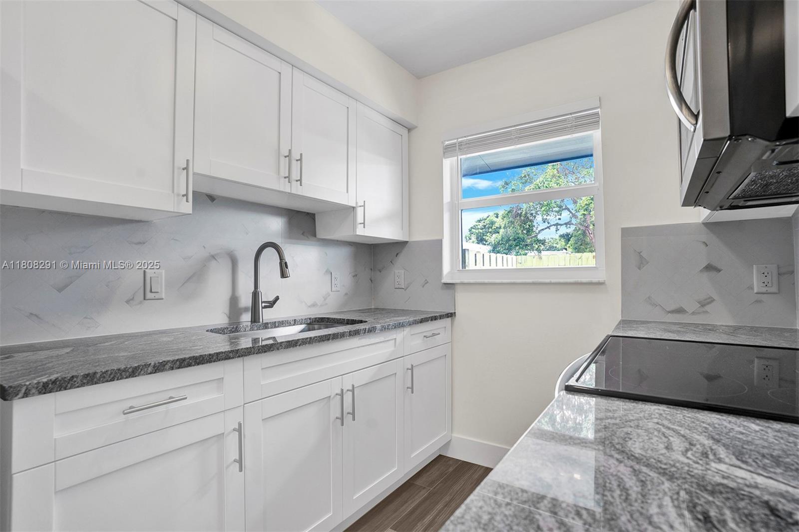 Newly renovated 1 bedroom apartment with NEW EVERYTHING! NEW kitchen with custom cabinets, granite counters and NEW stainless steel appliances. NEW spacious bathroom, NEW flooring, NEW lighting, NEW windows, NEW window treatments, laundry room with NEW washer & dryer! NEW central A/C. Completely fenced in, private patio with landscaping to enjoy the Florida Sunshine! One assigned parking space plus street parking. Tenant will pay all utilities. Qualified tenants with 650+ credit score & proof of income. First and Last month rent plus one month security deposit required, NO exceptions. Small pets ok (no aggressive breeds) with pet fee.