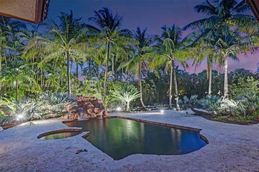 A Tropical Paradise Awaits. Nestled on a corner lot in one of the most sought-after areas in South Miami, this 5Bd/4Ba is one of only 9 exclusive homes that make up Ambience Estates. From the rare coral rock wall that encompasses the front perimeter to the custom, saltwater lagoon pool & waterfall in the back, this private oasis meshes opulence with tranquility. Step inside to elegant stone flooring throughout, soaring ceilings, formal living/dining rooms, & an oversized master suite with dual walk-in closets & access to the large covered terrace. Entertain outside on the coral rock pool & spa deck, amidst the professional & lush landscaping, surrounded by gorgeous palms swaying over your own personal beach. Live luxuriously in an ultra-quiet neighborhood in the perfect location.