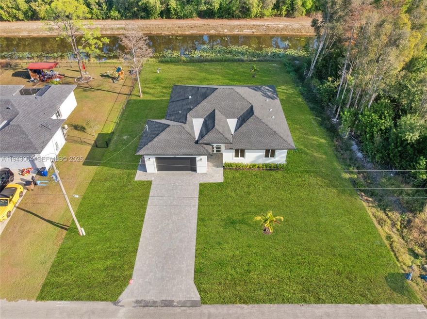 Brand new construction home featuring canal views in a quiet Lehigh Acres neighborhood. This newly built residence offers a modern open-concept layout with stylish modern finishes and a functional design perfect for everyday living. Enjoy relaxing or entertaining with peaceful water views right from your backyard. Conveniently located near shopping, dining, schools, and with easy access to SR 82 for commuting. A great opportunity to own a new home in a fast-growing area with no HOA.