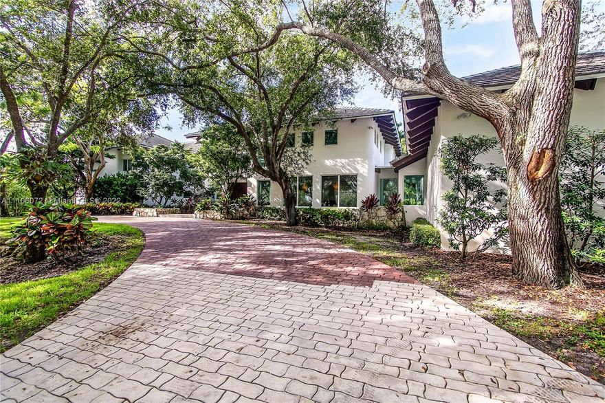 Stunning estate in coveted Pinecrest neighborhood of Miami. The home sits on 39,000 sq ft lot, on a quiet street, ideal for the privacy seeking homeowner. Featuring 6 beds + office/den and 7.5 baths, distributed through 7200+ sq. ft., with natural light and soaring beamed ceilings throughout. Spacious living areas, gourmet kitchen with top-brand appliances, 3 car garage add to the understated elegance of the property. Amenities, large heated pool and jacuzzi, large backyard with lush landscaping and majestic trees, veranda with summer kitchen, full-house generator, outdoor shower/pet-grooming area, basketball court and more. 3+ areas ideal for work-from-home. Top-rated schools nearby. Quintessential South Florida luxury living. Schedule a showing before it's gone! Motivated Owner!