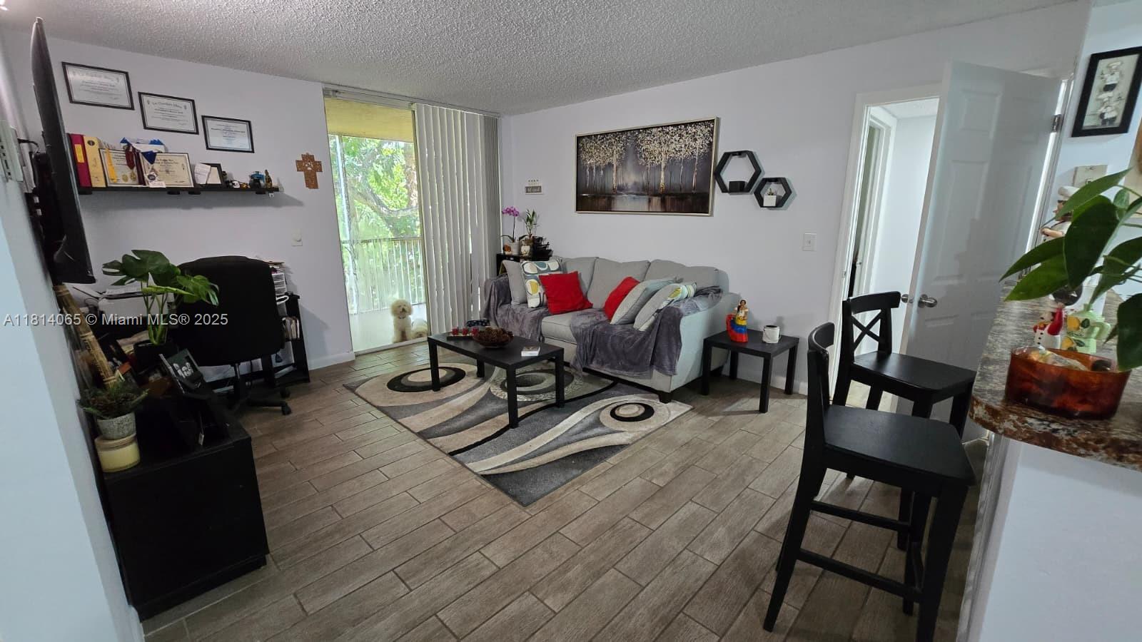 Come see this immaculate kept condo. With wood floors and spacious rooms, this is a must see to believe. Apartment comes with a garage parking space and another parking space uncovered. There is an option to purchase more. Balcony overlooks beautiful greenery, neighborhood is very quiet. Conventional 30% down. Easy to show.