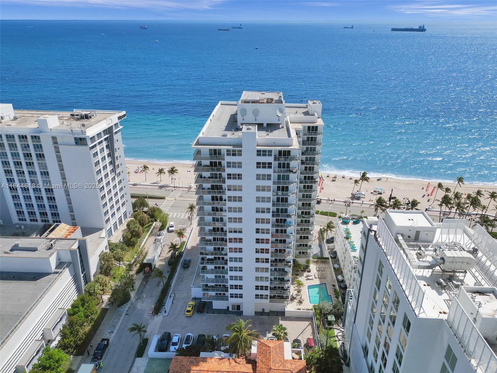 OCEANFRONT LUXURY LIVING! Seasons Condo has RESERVES! Prime location across from Atlantic Ocean! 2nd floor front SE corner unit w/direct ocean views! Steps to beach! Secure building w/24 hour front desk security. ALL ages. Sought after E stack. Open floor plan w/kitchen, full size W/D in unit, impact windows. 2-new A/C units April 2025. Newly renovated halls & front door! While tax record states 1 BR, layout configured for 2 BR/2 bath functionality. Roof: 5-yrs. Max 2 pets 25 lbs or less. 40 yr inspect. done 3/2022. Maint includes: cable, wi-fi, pest control, water, roof. 640 credit score per assoc. Heated pool w/BBQ area, party room, game room, gym. Near activities, shopping, water taxi, world class dining, night life, transport. 2 parking spots: 1 in garage + 1 behind bldg. Sold AS IS.