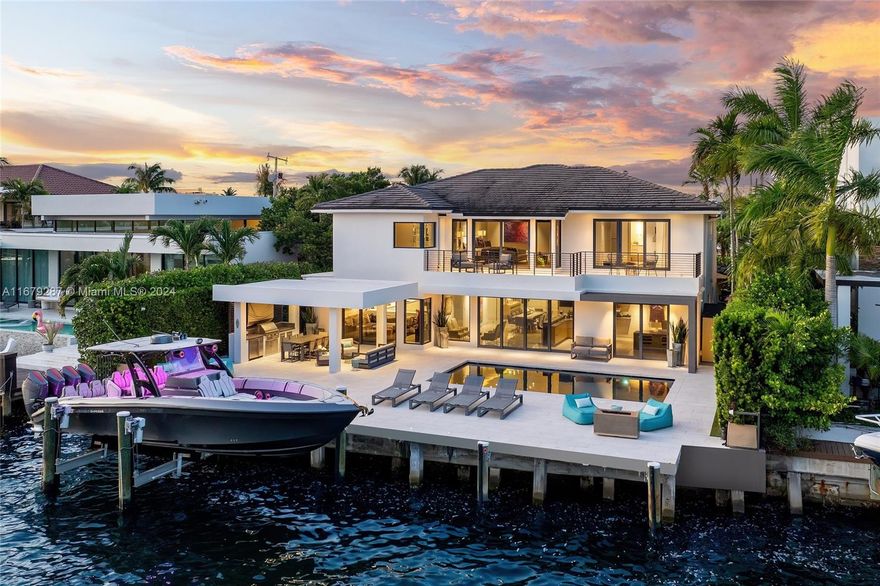 Discover modern luxury living at its finest in this newly reimagined 6-bedroom, 6.5-bathroom home. Boasting 5,750SF of meticulously designed space, this guard gated residence offers an open floor plan bathed in natural light through floor-to-ceiling windows. The European kitchen, equipped with top-of-the-line Sub-Zero & Wolf appliances, is a culinary enthusiast's dream. Entertain effortlessly w/a sleek bar featuring temperature-controlled wine storage that flows seamlessly to the outdoor pool area. The primary suite features a boutique style walk-in closet & breathtaking bay views. With 75FT of water frontage, you're just minutes from ocean access. Enjoy the convenience of nearby world-class shopping, and fine dining. Crestron-powered, this smart home defines sophisticated coastal living.