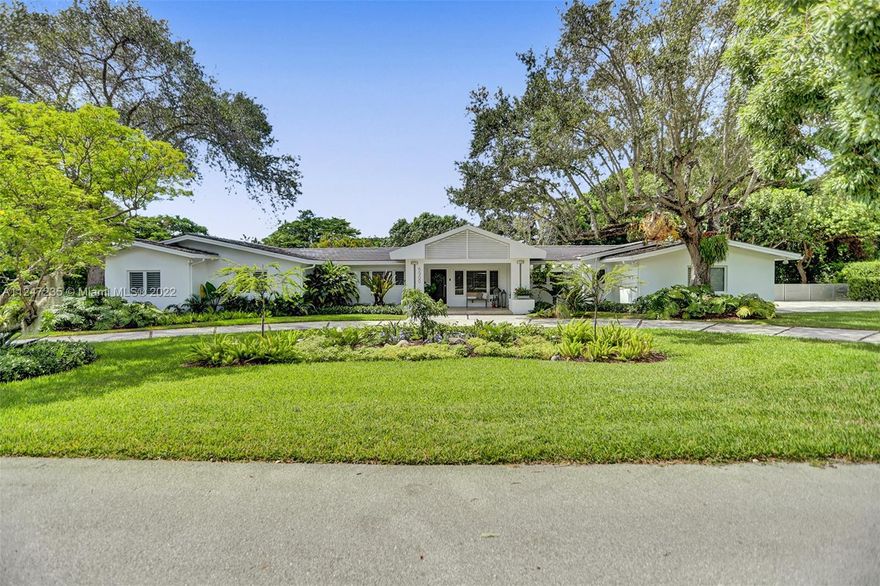 This turnkey North Pinecrest home melds Miami style and tropical ease steps away from Pinecrest Gardens. Experience a charming retreat in this 5 bed, 4 bath home remodeled in 2015. Highlights of this nearly 5,000 sf residence include a bright, airy formal living area leading to an expansive light-flooded family room, lofty ceilings, contemporary kitchen w Sub-Zero refrig, gas stove, butler’s pantry w Thermador oven,additional refrigerator, and ample storage. Relish in the stunning Florida landscape of the sprawling outdoor space, which includes a versatile kitchen and entertaining area for lavish nights of hosting or an elegant escape. The primary bedroom overlooking the lux pool area, flanked by lush foliage, has two spacious walk-in closets. Enjoy proximity to all of the Miami excitement