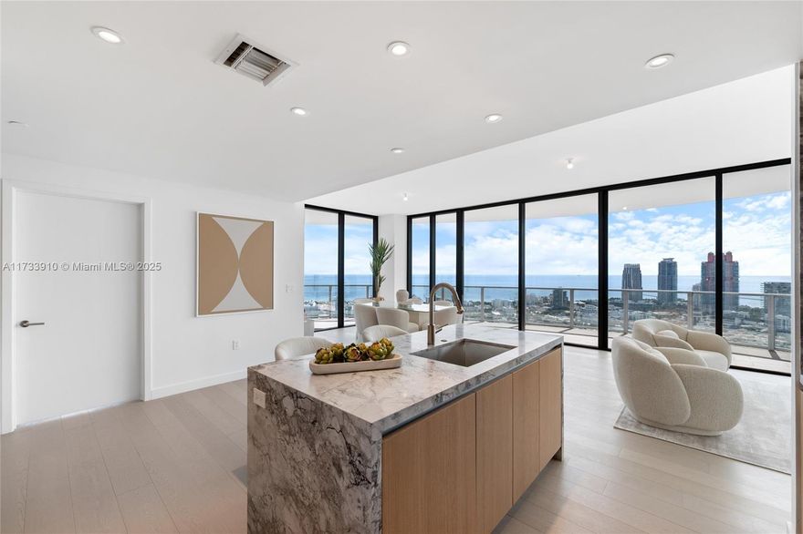 Welcome to Five Park, the epitome of luxury living in Miami Beach. Located in the prestigious South of Fifth neighborhood, this architectural gem by Arquitectonica offers 4,269 SqFt of expertly designed space. This brand- new corner unit features four bedrooms, four bathrooms, a powder room, and a private terrace, blending style and functionality seamlessly. With expansive windows, 10-foot ceilings, and a wraparound terrace, enjoy stunning ocean, bay, and city views. The Gabellini Sheppard-designed kitchen boasts Italian oak cabinetry, marble countertops, and Gaggenau appliances Residents access amenities including the exclusive Canopy Club on the 26th floor with private dining, wellness lounges, and personalized services. Seller financing available