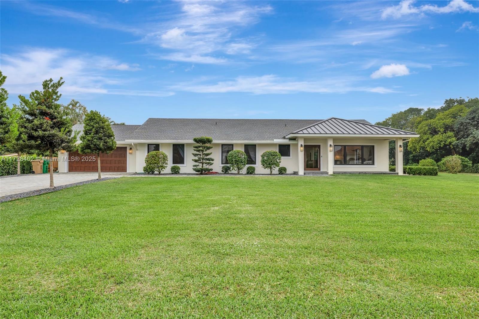 Nestled on nearly two acres, this 3,004 sq. ft. 4-bedroom, 3-bathroom home was remodeled in 2022 and features natural wood plank porcelain tile, quartz countertops, custom white oak cabinetry, Thermador appliances, a 36-inch gas rangetop, double ovens, a built-in microwave, and a bottom-freezer refrigerator. The backyard includes a Van Kirk 15 x 36 ft pool, 3,500 sq. ft pool deck, 3,000 sq. ft of turf, dual putting greens, and a 360 sq. ft Tiki hut with a bar, lighting, and TVs. Upgrades include a new HVAC system, metal and shingle roof, hurricane-impact windows, tankless water heater, 500-gallon propane tank, 30kW Kohler generator, and two-zone irrigation.