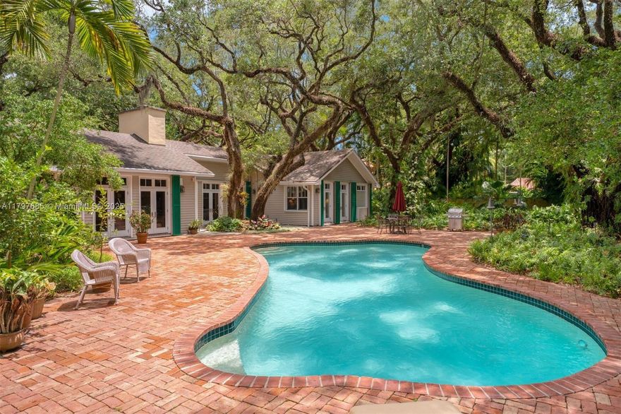Ponce Davis storybook acre estate of lush, curated tropical specimens & majestic oaks. Totally livable home & plenty of room to add a guest house without removing trees. MUST SEE TO APPRECIATE! This 4700 sf, 5/4 Cape Cod-style CBS home blends old Florida charm w/modern updates. Unique brick/wood accents, volume ceilings, cozy courtyards, & pool. 1992 extensive reconstruction w/multiple fully permitted updates since: remodeled primary suite & kitchen, PVC plumbing, electrical, 3 HVAC zones, smart tech & security system & hurricane ready windows/doors. This exceptional property in a non-flood zone offers the flexibility to enjoy as is, further personalize, or envision a new custom estate in one of Miami’s most coveted neighborhoods – just steps from dining, shopping, and top-rated schools.