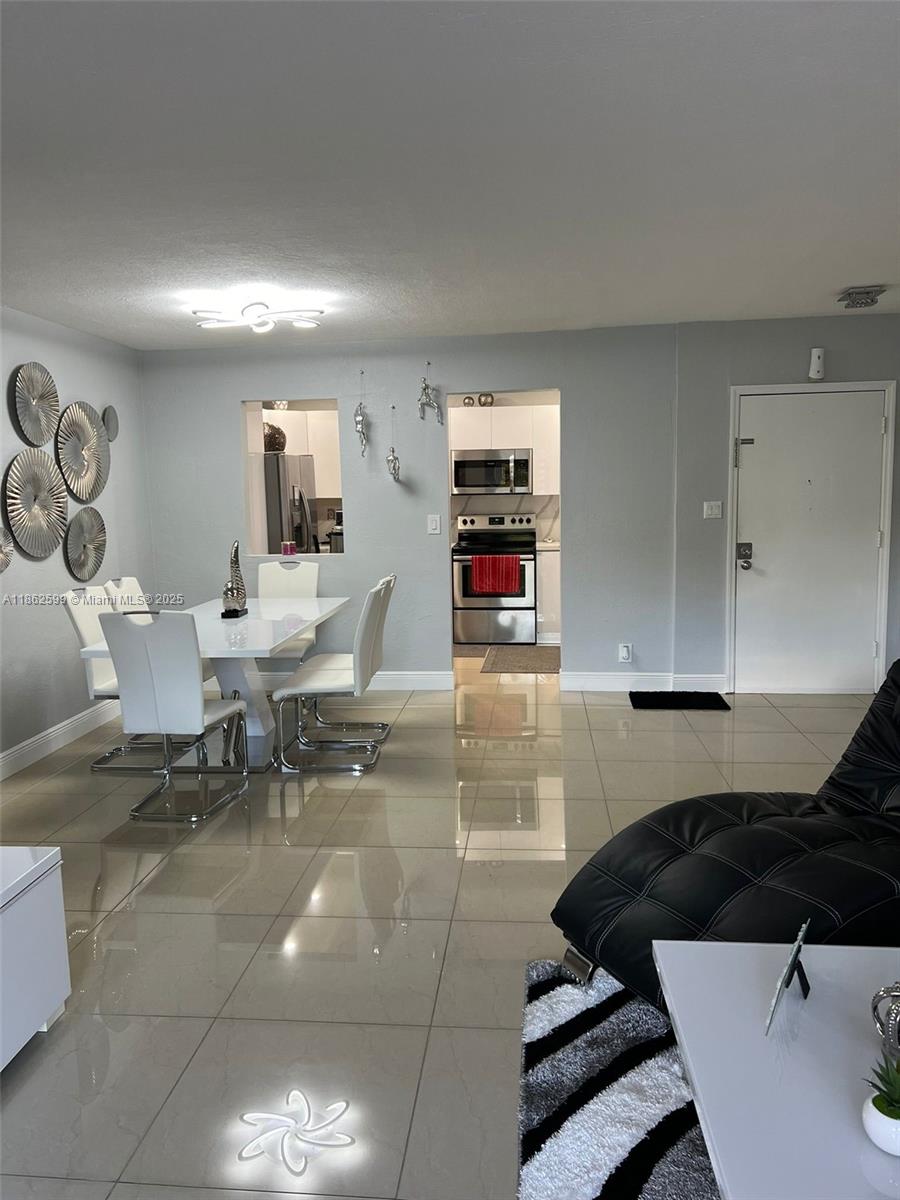 Beautiful 3-bedroom, 2-bathroom condo completely remodeled elegant porcelain flooring with sound-dampening underlayment, a new kitchen with brand-new stainless-steel appliances, washer and dryer in the unit, and 2 full showers. Located in a community with a golf course, pool, and a gym coming soon, it’s the perfect place to call home. Close to schools, shopping, and dining—schedule your showing today! Only first month and security deposit required. Won't last!