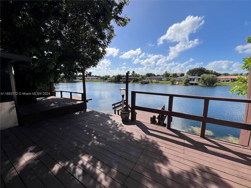 Amazing 3-bedroom, 2-bath waterfront villa/townhouse with house-like comfort and upgrades! Features a large wood deck, private dock, screened and open patio, tile floors, open kitchen, and abundant natural light. Includes 2 assigned parking spaces right in front. Just 2 blocks from Kendale Lakes Golf Course. Low $80/month HOA fee for maintenance.