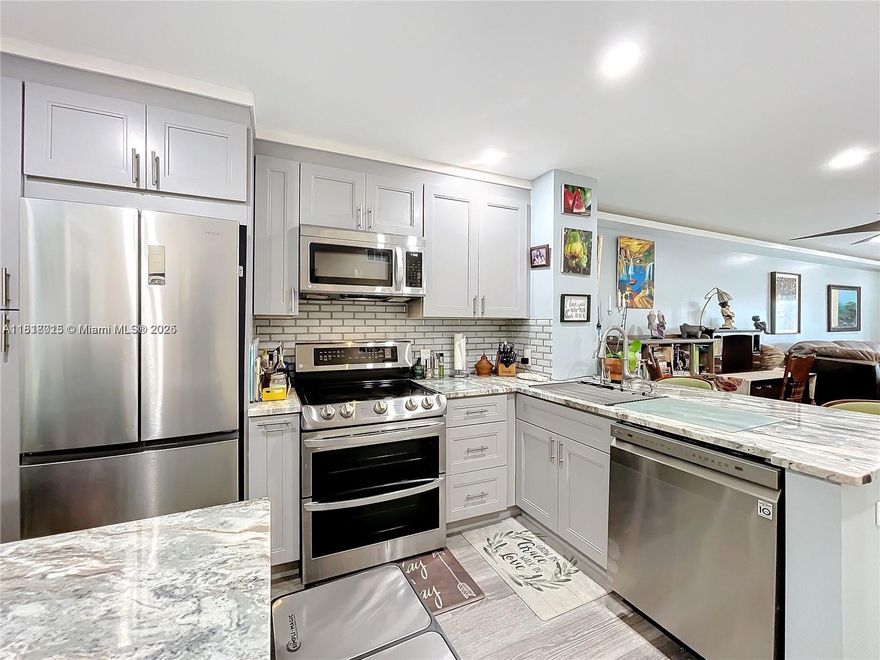 A must see recently remodeled 2-bedroom 2 bath updated condo with gorgeous sunset water views! Own your own slice of paradise on this private island. Under mile walk to the beach. Floor plan has been changed to accommodate walk in close, his and hers sinks and open concept kitchen. Allowing you to capture view on entry. Upgrades: quartz counter tops, new appliances, walk in shower bathtub ,new doors, new lighting and electric panel, water heater! Look no further this is where you want to be! Lovely tucked away condo community with clubhouse, BBQ and heated pool. Property is conveniently located nearby grocery stores, restaurants, Gulf stream casino & Horse track, tennis, pickleball court, dog park. Extra storage included with unit 1 parking space included, plenty of guess parking.