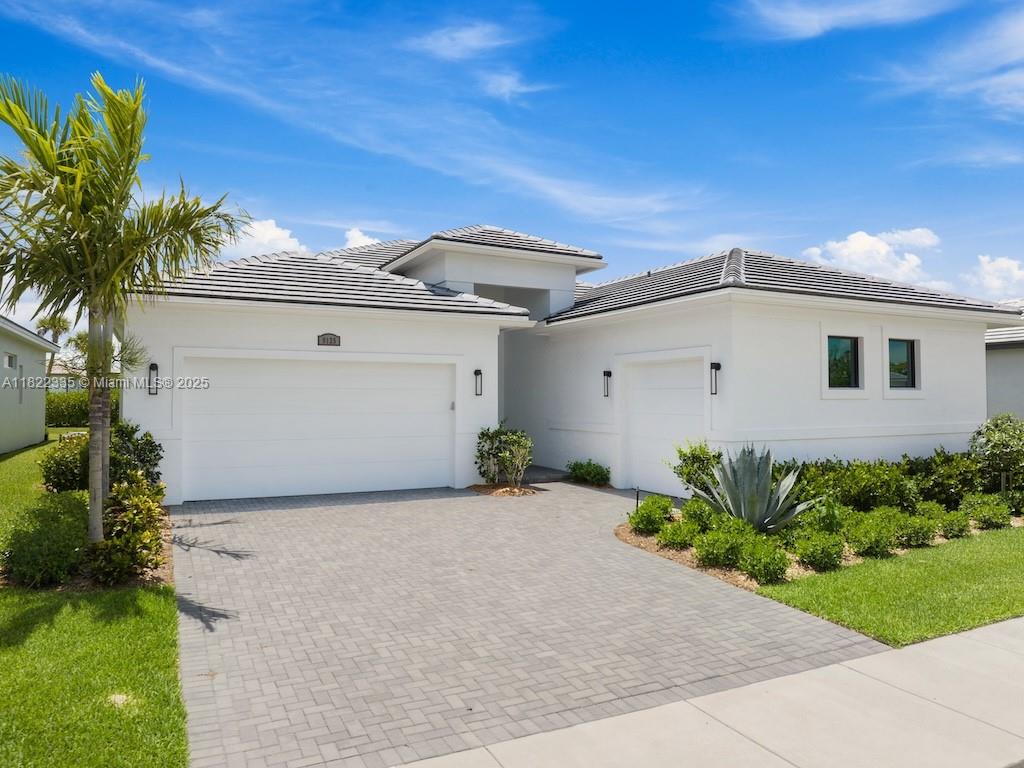 Sought-after Sydney model in PGA Village at Verano. Beautiful new home has $140K in upgrades, spacious open floor plan, ideal for entertaining. This home has 3 bedrooms, den & 3.5 baths. Upgraded chef’s kitchen has quartz countertops, high-end appliances, 36” induction cooktop & double wall ovens. Extended kitchen has wet bar & pantry. All bedrooms have en suite baths with walk-in frameless showers. Flooring in the main living area is plank ceramic tile. Built with impact windows, CBS construction & tile roof. Split 2-car & 1-car oversized, insulated garages provide ample storage. Enjoy indoor/outdoor living with 16’ sliding doors open to the lanai, with privacy wall, plumbed for an outdoor kitchen. Community features club with multiple pools, fitness, tennis, pickleball courts & more.