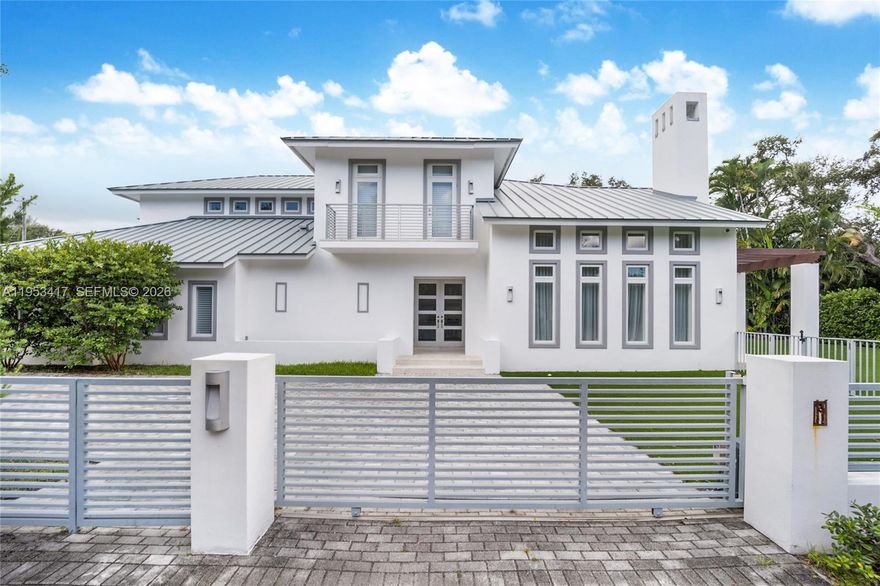 An exceptional executive home perfectly located in South Gables on a fully gated 15,000 sqft lot. Light filled living area with double height ceilings and working fireplace leads to a large formal dining.  Perfect for families, this home boasts a large eat in kitchen with oversized island and top of the line appliances and a huge family room complete with wet bar.  All rooms open to a sparkling tropical pool and large terrace, perfect for entertaining. The 2nd floor features an oversized primary suite with spa like bath and walk-in closet, a home office area and 2 bedrooms with ensuite baths all with balconies overlooking the pool. 2 additional ensuite bedrooms located on the first floor. This gated home has a 3-car garage with huge driveway with plenty of room for parking.