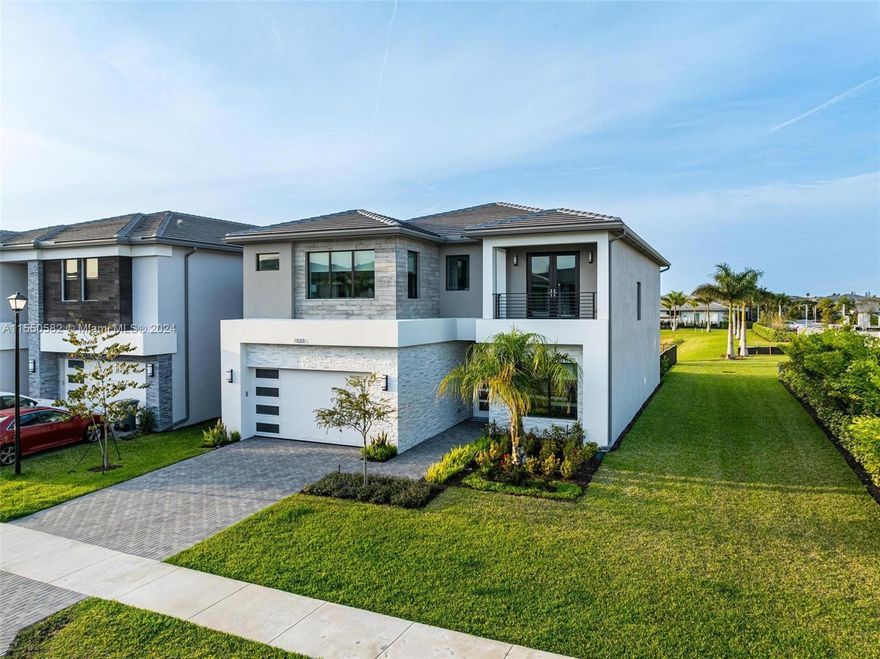 The gem you've been looking for at Lotus Palm awaits! Don't miss out on this opportunity to own a modern, fully upgraded, family home in Boca's latest modern haven walking distance from top schools. The exterior light wash wood and white stone sets the stage for the harmonious and zen feeling that flows through the entire home. Situated on a spacious corner lot, unparalleled privacy and a gentle breeze off the lake . This home is turnkey and ready for you to move in haste-free! Fully upgraded, including a heated pool with bubblers & lighting, custom automatic blinds, and an upgraded covered balcony off the master bedroom overlooking the tranquil lake. With Wolf appliances, upgraded floors, his and hers closets, and ample storage space, luxury meets practicality.