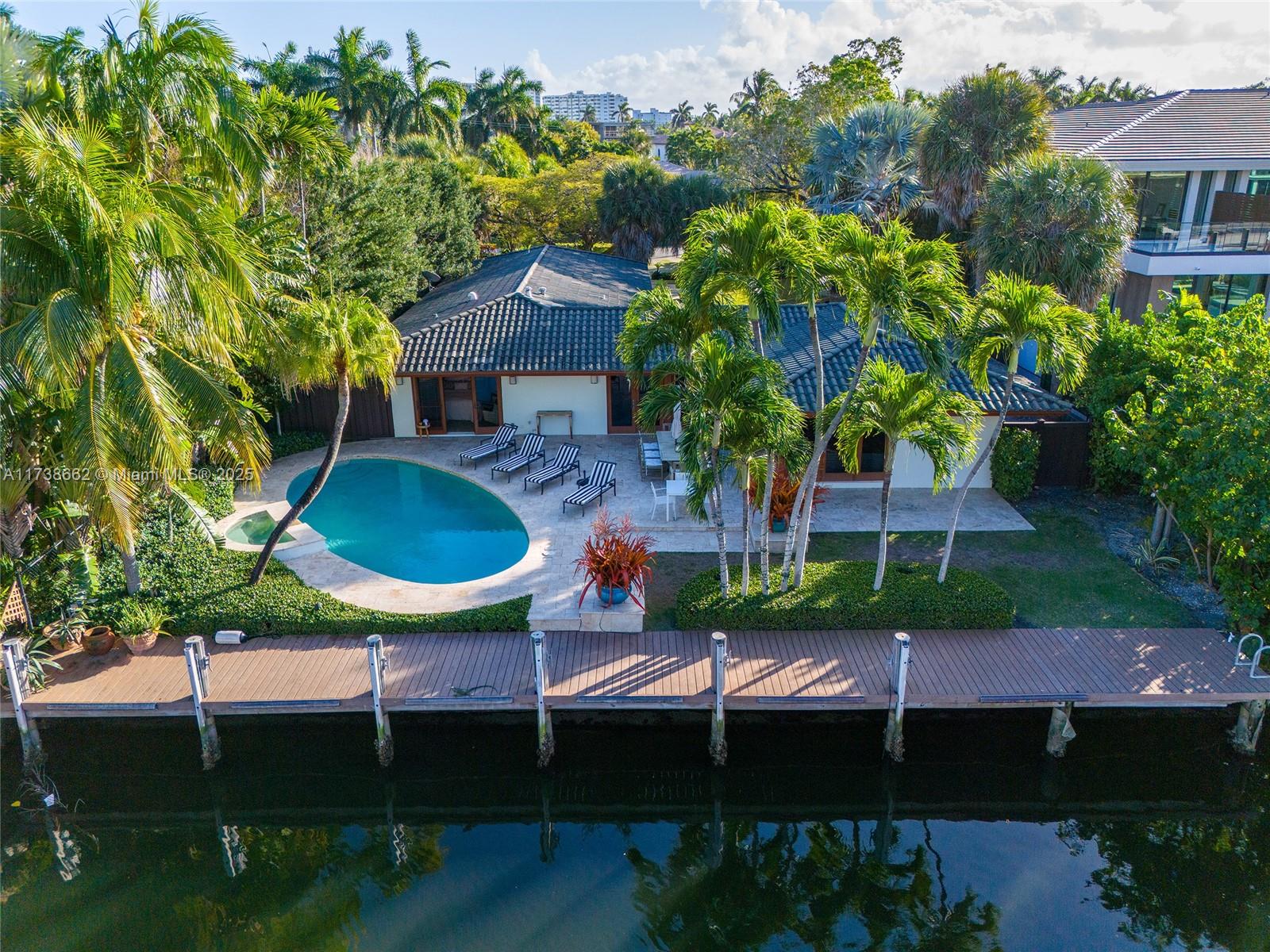 This charming house located in Sea Island features a cozy and great floor plan perfect for those who want to enjoy the south Florida living. Living/dining room opens to the pool area. Main bedroom with en-suite bathroom and dressing room with sitting area also facing the pool. The second bedroom has a view of the pool and the canal. The kitchen opens to a spacious family room perfect for entertaining friends and family. Private third bedroom with en-suite bathroom. Laundry room. Pool area great for entertaining with a BBQ and lounge. Residents enjoy kayaking and jet ski in the canal. Dock can accommodate up to a 60 feet yacht. Beautiful garden. Parking area can accommodate up to 4 vehicles. Electric Station. Sea Island offers guard-gate entrance and 24H security patrol. A must see!