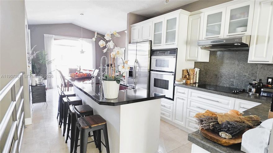 Gorgeous and fully updated 3-bedroom, 2.5-bathroom home with direct lake views, located in the highly desirable Hammocks community. This unique lake view three-story townhouse features a one-car garage and impact windows, marble floors throughout. The first floor offers a spacious primary suite with a sitting area and a beautifully updated primary bathroom featuring dual sinks and a shower. The second floor showcases an open-concept living and dining area, an updated kitchen, and elegant marble floors, along with both front and back balconies overlooking the patio and the lake. The third floor includes two additional bedrooms and a versatile open space ideal for a studio, office, or den. Enjoy a good-sized fenced patio with a porch and terrace, ideal for outdoor living ********ASSOCIATION FEES INCLUDES INSURANCE AND THE AMOUNT OF PROPERTY TAXES INCLUDES A LOAN OF YGREEN FOR IMPACT WINDOWS IN THE AMOUNT $2504.66 EVERY YEARS SO THE REAL PROPERTY TAXES IS AROUND $4,274.*******The Hammocks community offers resort-style amenities, including a large lake with a 5-mile walking and biking trail, small beach areas, swimming pools, tennis courts, and a gym. A must-see home—you will absolutely love it!