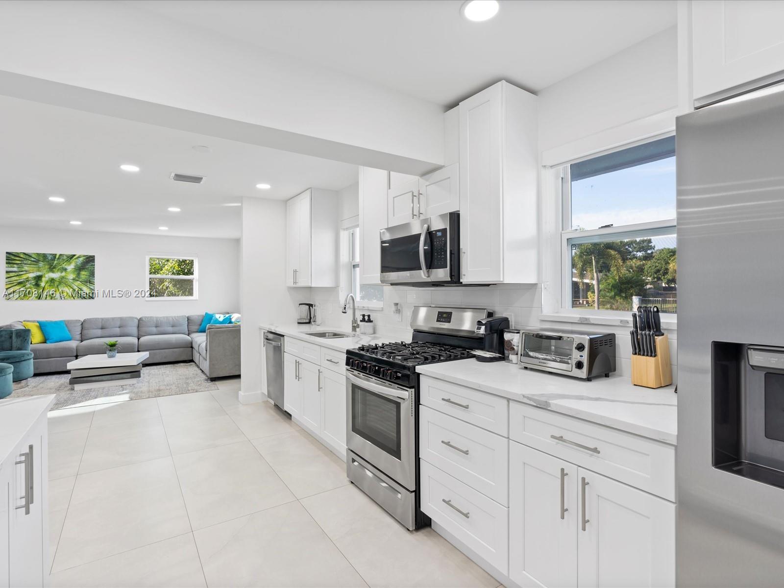 Discover this stunning family-friendly home with 5 beautifully renovated bedrooms and 3 bathrooms. Roof 2018, impact windows, and new A/C! The open layout connects to an inviting kitchen, creating a spacious and comfortable atmosphere. The expansive patio features a refreshing pool, shaded sitting area under a stylish awning, and covered storage room. Conveniently located near I-95, shopping centers, and restaurants, this home combines space and style for ultimate comfort and convenience. Enjoy modern living in a prime location!