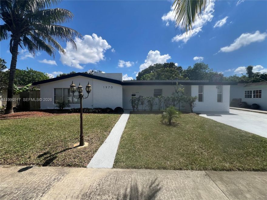 Welcome to this beautiful family residence of over 2,000 square feet under air in the quiet neighborhood of Miami Gardens! This spacious 3-bedroom, 2-bathroom home (with the option for a 4th bedroom or den) offers the perfect setting for a large or multigenerational family. Recently painted in bright white tones that fill the house with natural light thanks to its numerous windows. Enjoy a modern galley kitchen with solid wood cabinets in a dark tone, beautiful light quartz countertops, and stainless-steel appliances. The 24" porcelain tile floors in the living and common areas, LVP floors in the bedrooms, recessed lighting, baseboards, and plenty of closet space make this home feel modern and welcoming. The spacious master bedroom features its private bathroom and French doors that open directly to the huge, fenced backyard, ideal for family gatherings, barbecues, or simply relaxing under the mango tree. Outstanding features: New shingle roof Central Trane air conditioning only 3 years old Tankless water heater Washer and dryer inside the unit Sprinkler system Additional room perfect for office, storage, playroom, or formal dining Independent storage on the property Spacious fenced backyard with plenty of space Ample parking Located on a very quiet and safe street, this property is ideal for families looking for comfort, space, and a move-in ready home. Walk to the Hardrock stadium to view FS 1, Miami Dolphins, FIFA, World Cup, Tennis, concerts and many other events.
