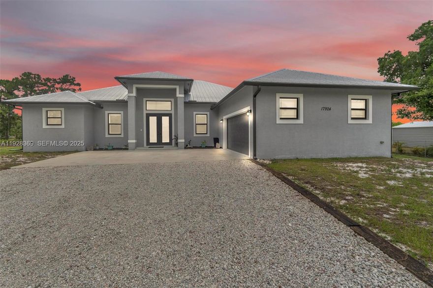 Built in 2022, fully fenced 1.29 acres on canal. Total 3434 sq ft with 2620 under air. Hurricane impact windows and doors. Bright and airy vaulted great room with wood-look tile. Spacious kitchen with LG SS appliances, apron sink, granite countertops, and 14-foot island. Oversized master has tray ceiling and walk-in closet with built-in organizers and dresser. Master bath has private water closet, dual vanities, and dual shower heads. Features whole home Reverse Osmosis filtration system with 500-gallon tank, A/C with Halo UV, Metal roof, spray foam insulation, epoxy garage, pre-wired for exterior cameras, in-wall pest control system, covered back patio with fans, large, heated pool with 6 ft sun shelf. Walking distance to highly rated Elementary & Middle schools.