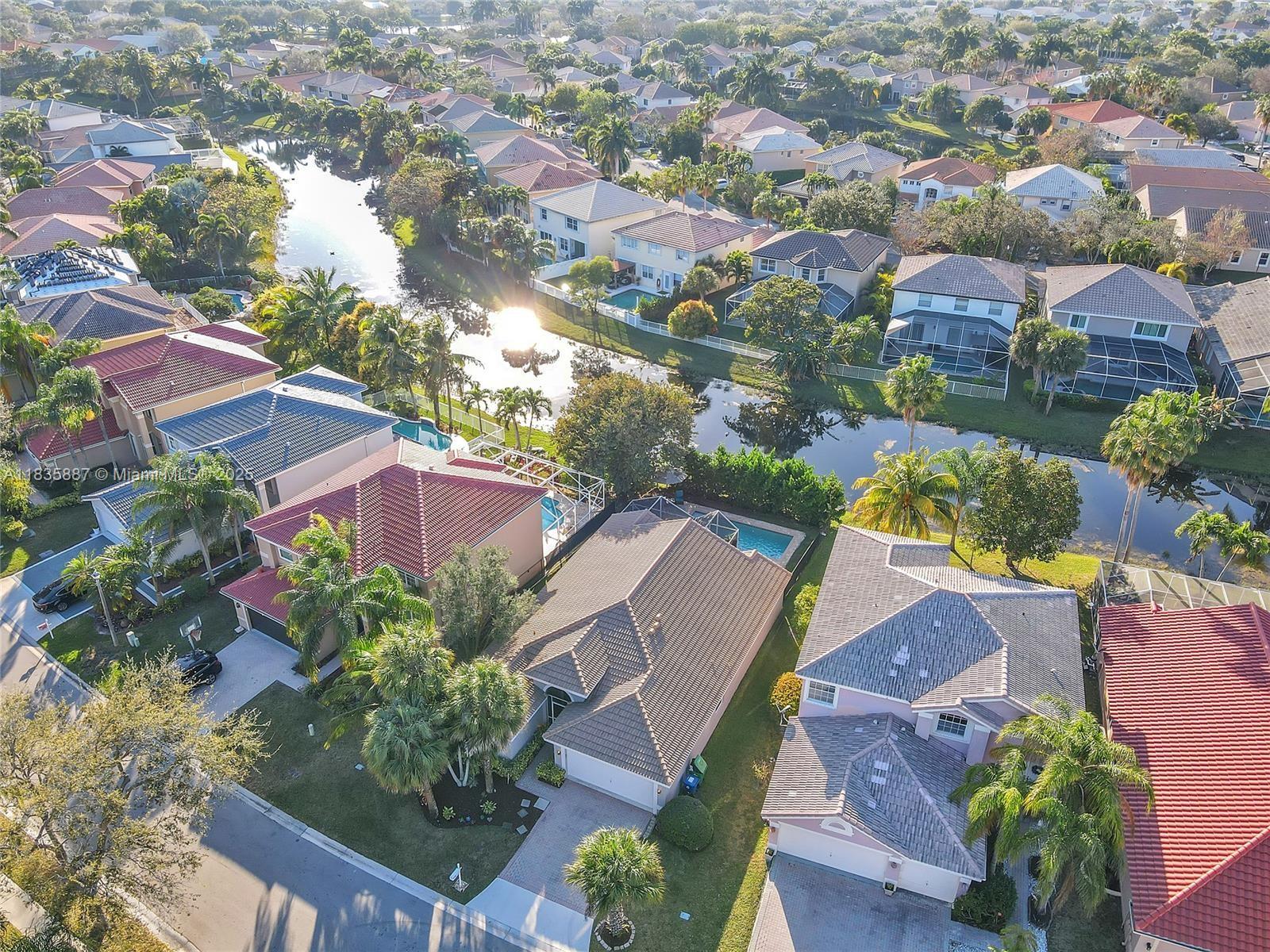 Experience S. FL living in this stunning 3/2 waterfront pool home in the gated community of The Island @ Wyndham Lakes! Some pics have been virtually staged. Upon entering, you will find luxury laminate Mohawk flooring, both waterproof & scratch resistant, along w/ a freshly painted interior & exterior, 2024. Step into your tastefully updated kitchen, complete w/ white cabinets, granite countertops, & SS GE appliances. The spacious primary bedroom features his & hers closets, along w/ a huge en-suite bathroom, complete w/ dual vanities & a separate shower & soaker tub. The backyard is an entertainer's dream, w/ a screen enclosed patio & a pool overlooking the lake. The roof was replaced in 2018, WH replaced in 2020, A/C & Insulation replaced in 2022, all new Impact Windows & Doors in 2023.