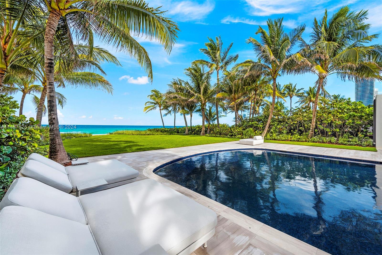 Modern tropical oasis nestled between swaying palm trees on the Atlantic Ocean in exclusive Golden Beach, Miami! Indulge on abundance of extravagant amenities and panoramic ocean views, with the beach as your backyard! The 12,000-SF mansion just underwent a million-dollar makeover and is staged by Artefacto’s sublime collection of furniture that blends with the beach vibes. Oceanfront living areas include a wet bar, gourmet kitchen, elegant dining rm, family rm, living room, huge terrace with summer kitchen. Dreamy primary suite has marble hers/his baths, walk-in closets. Ground floor entertainment space features a show-stopping, Shelby Cobra - courtesy of Prestige Imports. Amenities: rooftop, theater, guesthouse, 4 kitchens, elevator, patio, cabana. Furniture and car, avail separately.