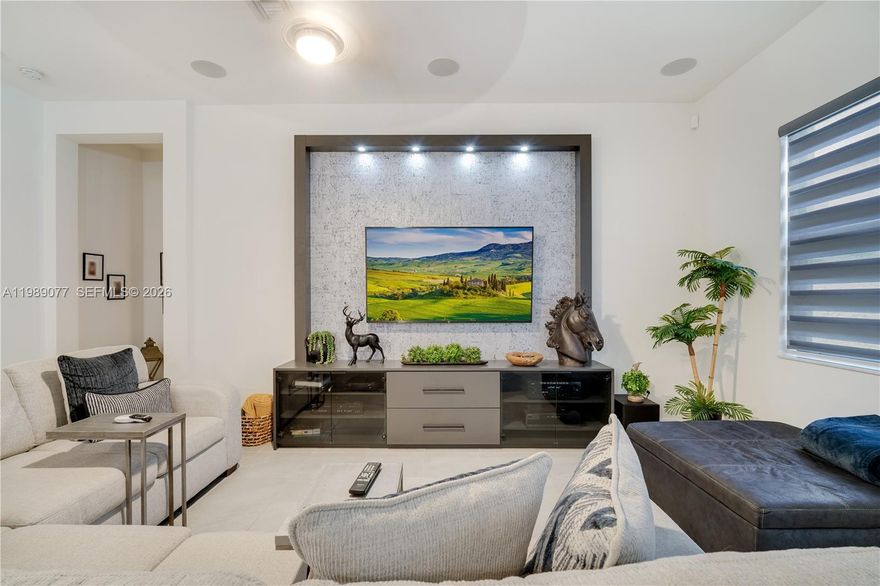 Experience modern luxury in this stunning 4-bedroom, 3-bathroom single-story residence, where high ceilings and designer window treatments create an airy, sophisticated ambiance. The open-concept living space is anchored by a striking decorative wall and a family room featuring a custom built-in entertainment unit and ceiling-mounted surround sound. The chef-inspired kitchen boasts an upgraded oversized island and a walk-in pantry with ample storage. Retreat to the primary suite to find a meticulously crafted custom closet. Outdoor living is redefined in the private backyard, fully enclosed by a PVC fence with dual side gates and featuring extensive premium pavers wrapping the home and extending to an oversized driveway. Entertain under the custom pergola, equipped with integrated lighting and a cooling fan. Modern essentials include a security camera system with a dedicated monitor and overhead garage storage racks. Residents enjoy resort-style amenities including a clubhouse, fitness center, pool, and playground. With its prime location near Memorial Hospital and easy access to I-75 and the FL Turnpike, this home offers the perfect balance of luxury and convenience. This turn-key property is ready for its most discerning buyers.