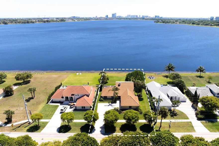 Stunning Downtown WPB City views from this Beautiful 4BR/3BA home on scenic Lake Mangonia. Light & bright. This immaculate residence offers a spacious family room, living & formal dining room. Sliders open to a covered screened lanai overlooking a huge yard—perfect for entertaining, barbecues, or adding a pool/fire pit. Primary suite & 2nd bedroom/office on the 1st floor; 2 oversized bedrooms upstairs. Solid construction with concrete tile roof, accordion shutters & deep driveway. Enjoy sailing, paddle boarding & canoeing on Lake Mangonia—no HOA Fees. Minutes to CityPlace, restaurants, shopping & top-rated BAK school. Feel the Florida sunshine & Waterfront breezes. The perfect blend of space, location, and Florida Lifestyle.