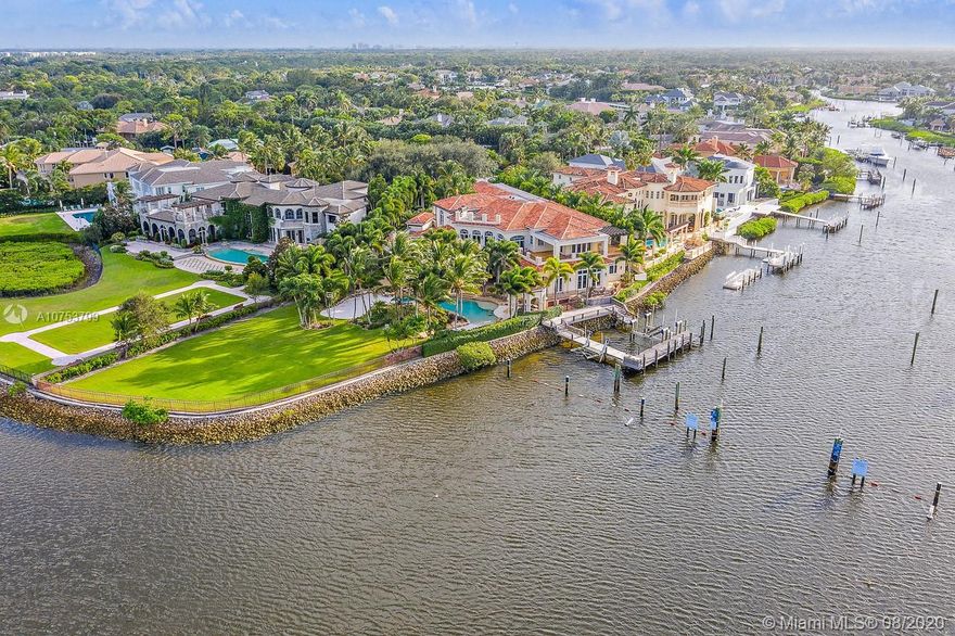 Location Location Location! A BOATERS DREAM - Point Intracoastal lot in Prestigious Admirals Cove.  This property has almost 300' of water frontage, (see survey in documents) and is a one of a kind property.  Dockage on the canal for a 85+ boat, plus 2 additional boat lifts.  New roof in 2019, and freshly painted interior.  This smart home has a room for everything, wine room, theater, office, golf range, chefs kitchen, guest wings ... you name it, it has it.  Enjoy countless hours outside by the resort style pool, outdoor bar and summer kitchen, covered loggias and one of the largest lots in Admirals Cove.