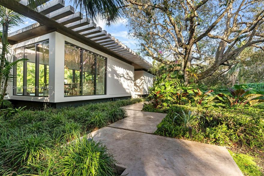 Unique, Modern, award-winning architectural masterpiece located on a quiet street in the heart of Pinecrest. This spectacular one-story home has six beds, 6.5 baths, and two separate office spaces. The finest finishes are welcomed by an expansive open floorplan overlooking the heart of the house: a heavily landscaped courtyard featuring an 80-foot-long pool. The home was designed by "Brillhart Architecture" with a structural system that includes steel columns but mainly pure concrete. Smart home with a full-capacity generator, outdoor kitchen, and a state-of-the-art tree house. The guest bedroom and maid's quarter are detached and have separate entrances. An architectural experience that you must see to appreciate genuinely.