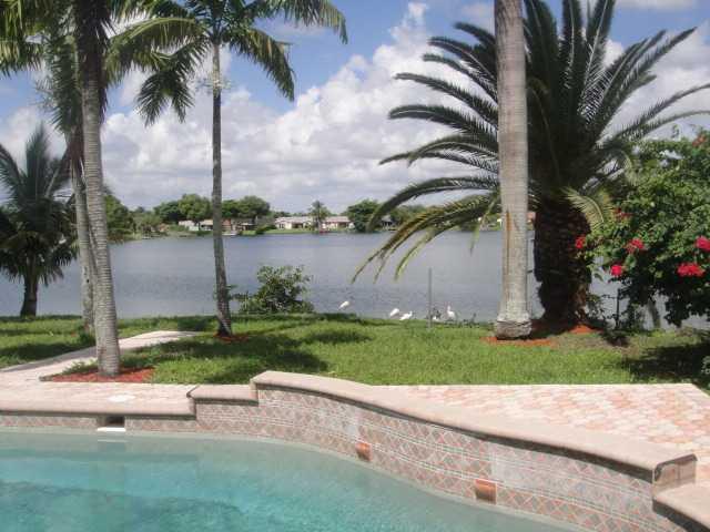 LIKE-NEW 5/3 LAKEFRONT POOL HOME IN QUIET FAMILY NEIGHBORHOOD. EXPANDED MODEL WITH 2766 S/F! THIS MAGNIFICENT HOME IS IDEAL FOR ENTERTAINING WITH A GORGEOUS BACKYARD RETREAT! NEW KITCHEN W/ SELF CLOSING WOOD CABINETS, GRANITE AND SS APPLIANCES. ALL NEW BA THS WITH HUGE MASTERBATH! 2 NEW A/C UNITS, NEW ROOF, NEW ACCORDION SHUTTERS,NEW RECTIFIED DIAGONAL TILE FLOORS THROUGHOUT. HUGE FAMILY ROOM!NEW HW HEATER, WASHER DRYER AND WORKSHOP WITH CABINET STORAGE. RAPID APPROVAL FOR QUALIFIED TENANTS! NO HOA HASSLE!