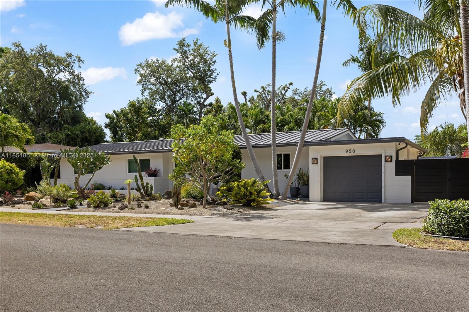 Modern Oasis in Miami’s Upper East Side! This stylish single-story home blends mid-century charm with modern upgrades. Set apart by unique landscaping with cacti and rare plants, it offers a serene retreat. Enjoy a brand-new custom kitchen with quartzite countertops, renovated bathrooms, and sleek metal fencing for added curb appeal. Inside, the open layout features original terrazzo floors and large impact windows that flood the space with natural light. The converted garage adds a spacious fourth (4th) bedroom and laundry area. Out back, relax in the covered outdoor dining/living space, with a yard for kids, pets, and entertaining. Ideally located walking distance from Military Trail Park & Dog Park and minutes from Biscayne Bay, Downtown, and beaches. Schedule your showing today!