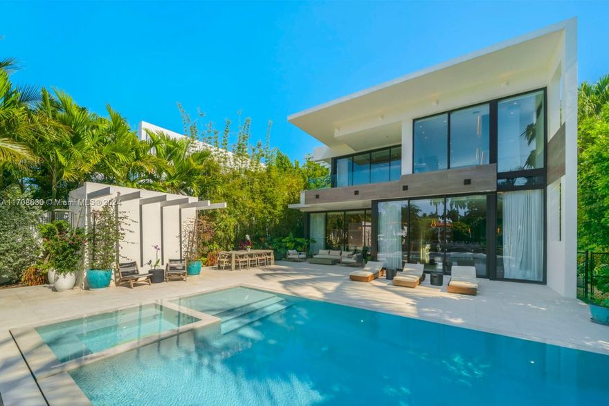 "TwinPalms", organic modern WF masterpiece, on exclusive Sunset Island III, steps from Sunset Harbor. Gated estate on guarded island, designed to perfection w/ warm, exotic finishes. Enter through Buddha belly & Gracilis bamboo, curated tropical gardens, water features, living oolite & waterfalls. Bridged entry of floor-to-ceiling glass, leading to 5BR/6+2BA. Featuring smart lighting/sound, movie room, wine/wet bar, European white oak, poured terrazzo, professional chefs kosher kitchen w/ Wolf/Subzero, & quartzite islands, 2 car double height garage, staff quarters & rooftop. Master boasts 2 walk-in closets, 2 balconies, midnight bar, hand crafted marble bathroom w/ steam shower overlooking the WF. Outdoor living, positive edge pool w/ spa, cabana bath, outdoor shower, dock, boat lift.