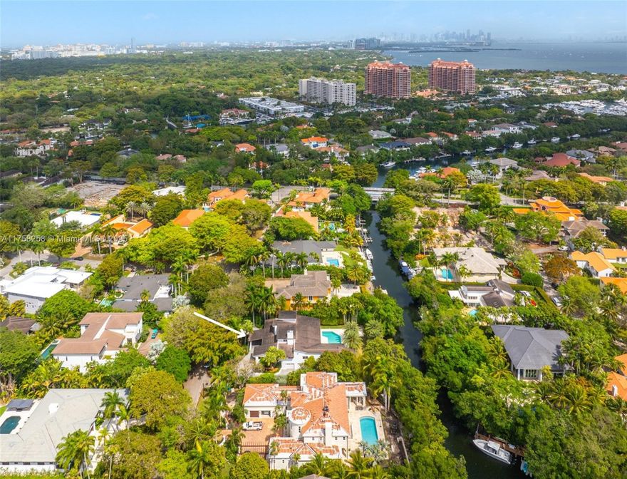 This unmatched, move-in ready, Cocoplum waterfront home offers the lowest price per SF on the water-providing an extraordinary opportunity to further increase its value. It also boasts 115 waterfront feet, a private dock, 2 drive-on Jet Ski docks & mere minutes to the open bay! The gated residence features bright, open living space, a Viking-equipped kitchen, 5 en-suite bedrooms, including a 1st-floor primary suite with companion walk-in closets & 2 office/flex rooms. Additional highlights include: an elevator & 2-car garage with extra storage. Its lush exterior features a pool, patio and gorgeous greenery; its prime Coral Gables-meets-Coconut Grove location places you near top schools, parks shopping & culture. A rare chance to invest, live in or transform a premier Gables waterfront gem.