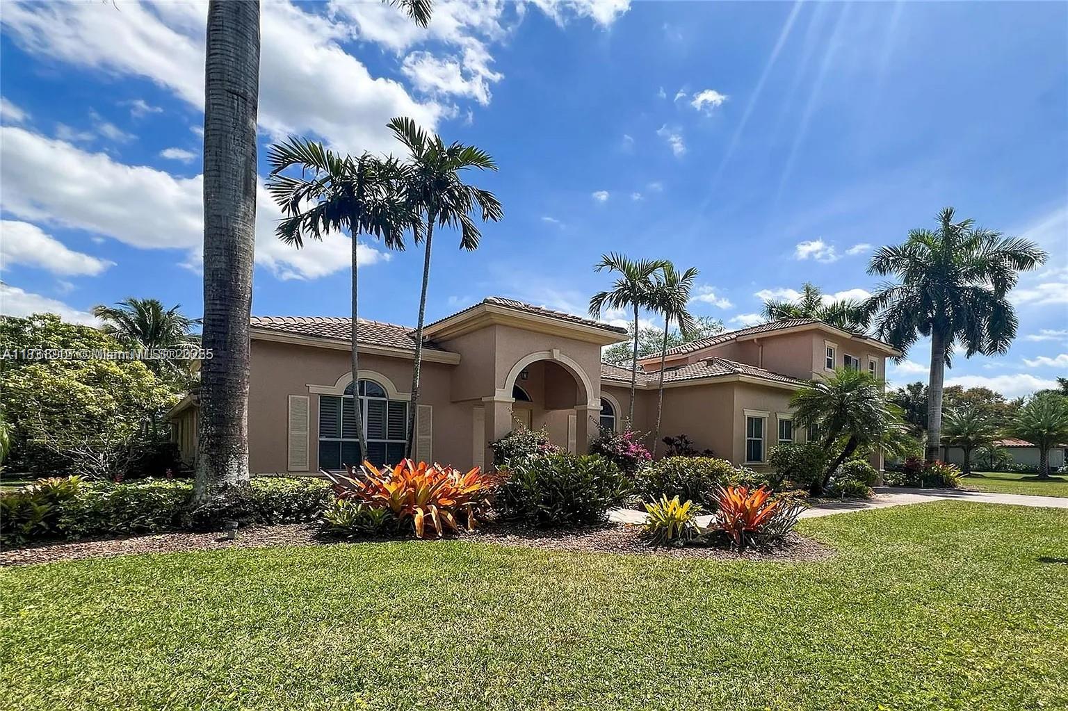 Experience refined luxury in this exquisite estate home with panoramic lake views and lush tropical landscaping surrounding a resort-style pool. Located in the prestigious Saddle Brook community of Davie, this 6-bedroom, 5.5-bath residence offers a 3-car garage, soaring volume ceilings, and marble flooring throughout the main level. The gourmet kitchen features top-tier appliances and a gas cooktop. Additional highlights include a 2021 roof, full-impact windows, whole-house generator, custom walk-in closets, and elegant designer finishes throughout. A true masterpiece of comfort and sophistication.