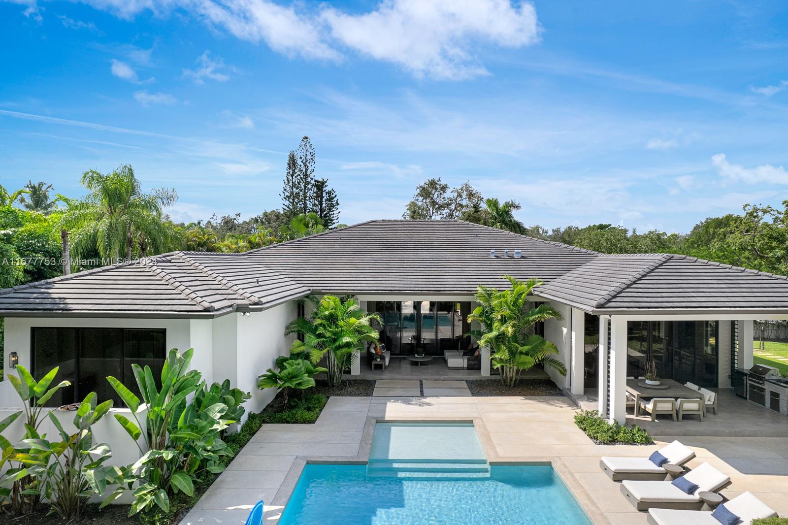 Luxury awaits in this Pinecrest modern estate, custom-built in 2020 with state-of-the-art construction and impeccable finishes. Set on a spacious 32,234 sq. ft. corner lot, this single-story residence boasts a 5-bed/5.5 bath open floor plan and a 2-car garage with impact windows & doors throughout. Enjoy expansive living areas, a family room, a wine gallery, and a bar – perfect for entertaining. The kitchen is a chef's dream with top-of-the-line Thermador appliances, a walk-in pantry, custom wood cabinetry, & quartz countertops. The master suite features double walk-in closets and a resort-style bathroom. Outside, indulge in the beautiful pool and a perfect backyard oasis for entertaining. Luxuriate in a lifestyle seamlessly blending sophistication with home comforts. By appointment