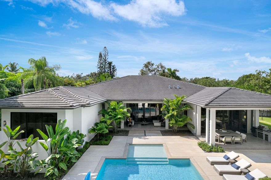 Luxury awaits in this Pinecrest modern estate, custom-built in 2020 with state-of-the-art construction and impeccable finishes. Set on a spacious 32,234 sq. ft. corner lot, this single-story residence boasts a 5-bed/5.5 bath open floor plan and a 2-car garage with impact windows & doors throughout. Enjoy expansive living areas, a family room, a wine gallery, and a bar – perfect for entertaining. The kitchen is a chef's dream with top-of-the-line Thermador appliances, a walk-in pantry, custom wood cabinetry, & quartz countertops. The master suite features double walk-in closets and a resort-style bathroom. Outside, indulge in the beautiful pool and a perfect backyard oasis for entertaining. Luxuriate in a lifestyle seamlessly blending sophistication with home comforts. By appointment
